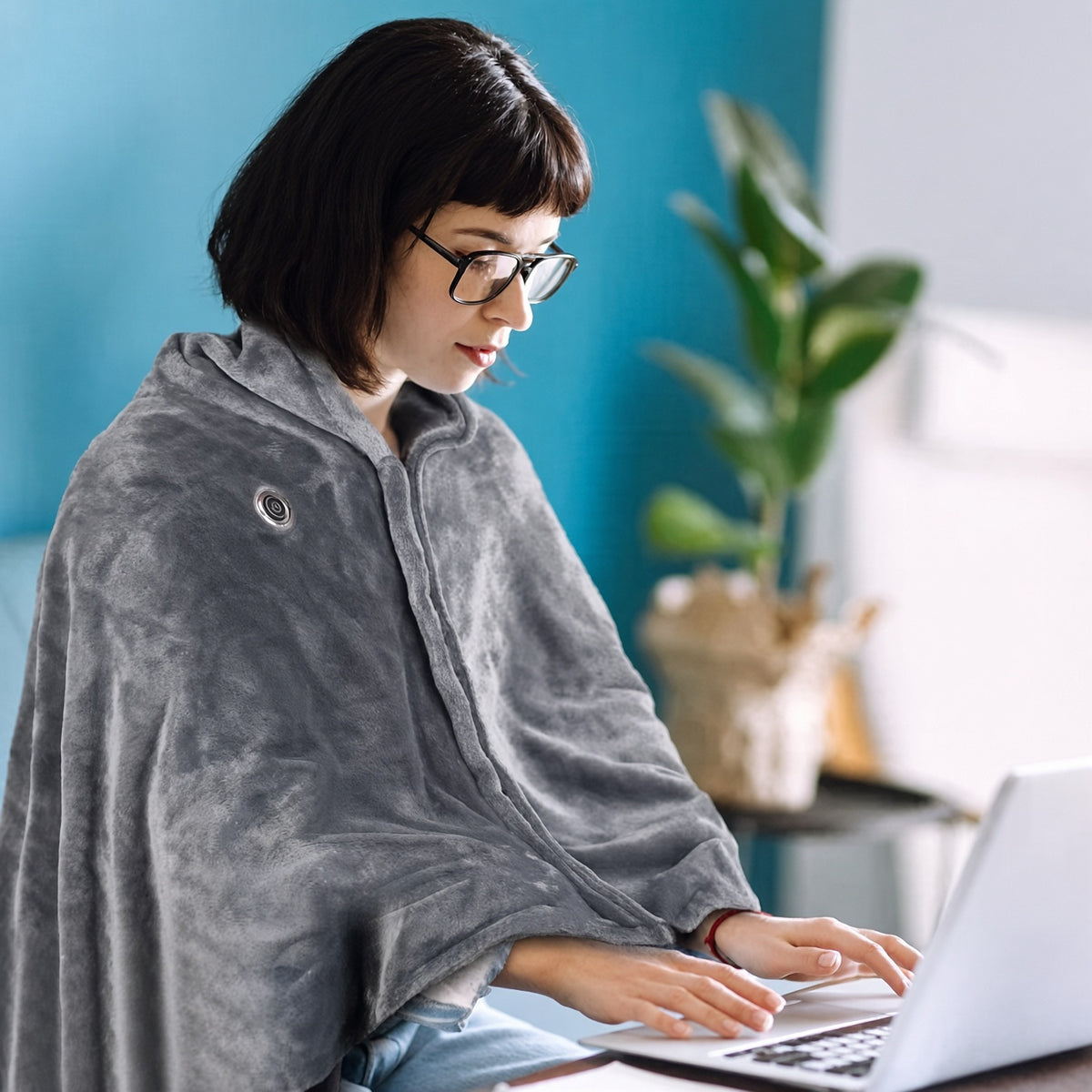 AI-generated image: woman wearing the heated poncho at a laptop